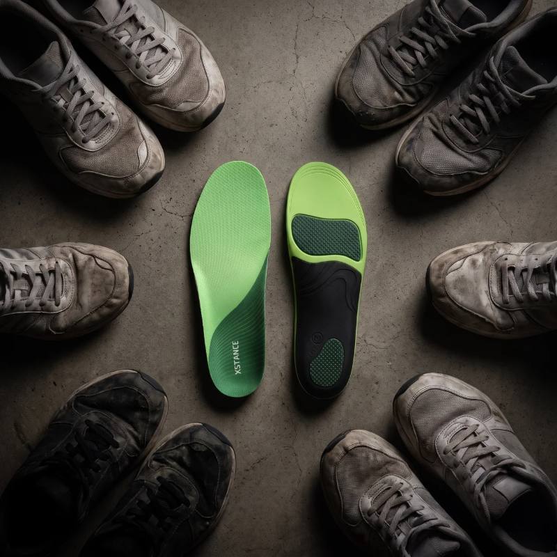 XSTANCE insoles at the center, surrounded by worn-out shoes that didn't work